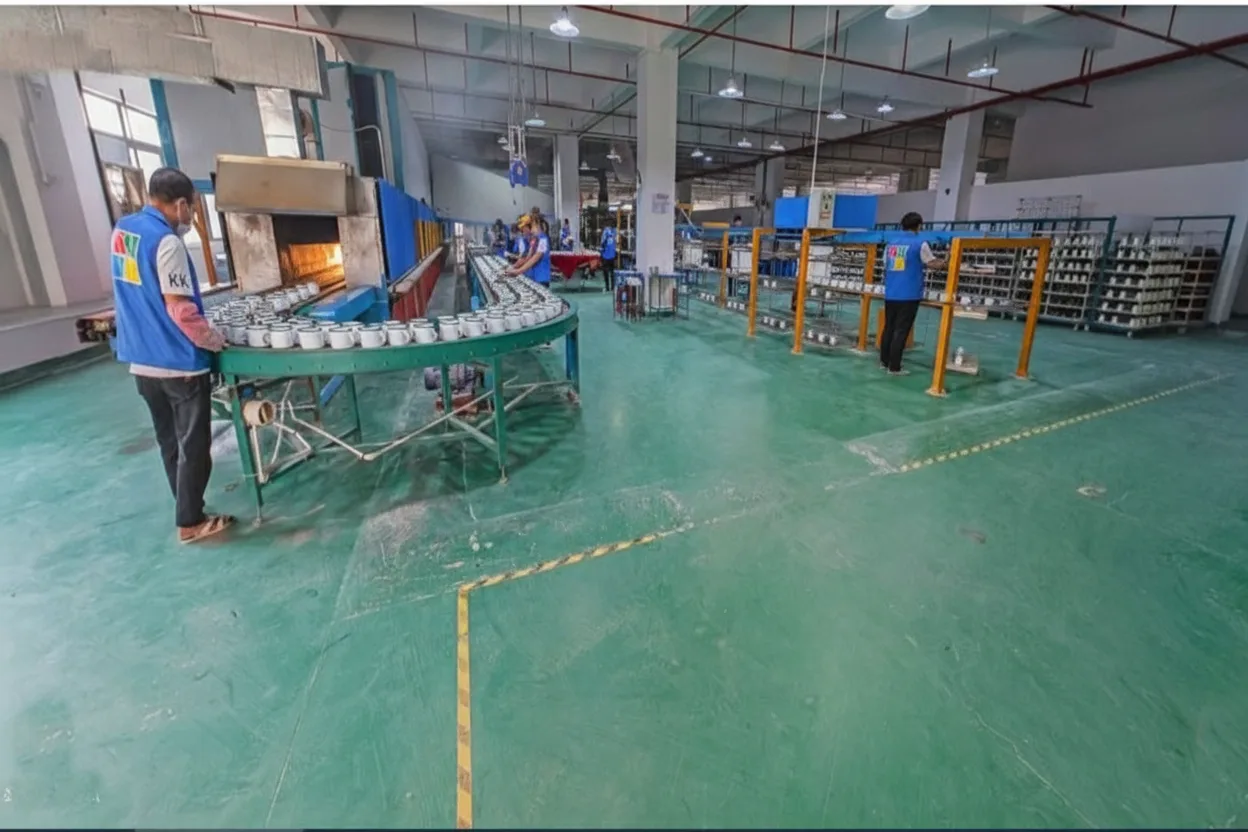 Factory production line showing multiple enamel mugs in manufacturing process