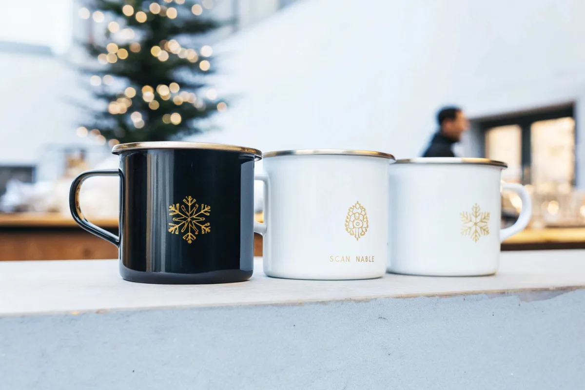 Festive holiday enamel mugs featuring snowflakes, evergreen trees, and warm red and gold color palettes (ID#2)